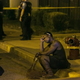 A woman sits on the curb as Chicago police investigate an August scene where gunfire at a birthday party left a man dead and a woman injured. (Credit: Ashlee Rezin/Chicago Sun-Times)